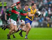 9 April 2023; Enda Smith of Roscommon in action against Jordan Flynn and Matthew Ruane of Mayo during the Connacht GAA Football Senior Championship Quarter-Final match between Mayo and Roscommon at Hastings Insurance MacHale Park in Castlebar, Mayo. Photo by Ray Ryan/Sportsfile