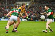 9 April 2023; Enda Smith of Roscommon in action against Ryan O'Donoghue, left, and Conor Loftus of Mayo during the Connacht GAA Football Senior Championship Quarter-Final match between Mayo and Roscommon at Hastings Insurance MacHale Park in Castlebar, Mayo. Photo by Ramsey Cardy/Sportsfile