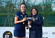 13 April 2023; Captain Hannah McLoughlin is presented the cup by Vice President of Hockey Ireland Barbara O'Malley during the UCD Ladies Hockey EYHL medal presentation event at UCD Hockey Stadium in Belfield, Dublin. Photo by Tyler Miller/Sportsfile