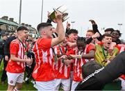 15 April 2023; St Joseph’s captain Scott Higgins celebrates with the trophy and teammates after their side's victory in the FAI Youth Cup Final match between St Joseph’s AFC, Dublin, and College Corinthians AFC, Cork, at the Carlisle Grounds in Bray, Wicklow. Photo by Seb Daly/Sportsfile