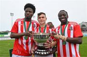 15 April 2023; St Joseph’s players, from left, Emmanual Ogunsaikon, Alan Seruga and Aji Habeeb with the trophy after their side's victory in the FAI Youth Cup Final match between St Joseph’s AFC, Dublin, and College Corinthians AFC, Cork, at the Carlisle Grounds in Bray, Wicklow. Photo by Seb Daly/Sportsfile