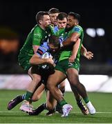 15 April 2023; Max Llewellyn of Cardiff is tackled by Bundee Aki, right, and Jack Carty of Connacht during the United Rugby Championship match between Connacht and Cardiff at Sportsground in Galway. Photo by Ben McShane/Sportsfile