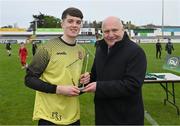 15 April 2023; St Joseph’s goalkeeper Dylan Kane is presented with his Player of the Match award by FAI President Gerry McAnaney after the FAI Youth Cup Final match between St Joseph’s AFC, Dublin, and College Corinthians AFC, Cork, at the Carlisle Grounds in Bray, Wicklow. Photo by Seb Daly/Sportsfile
