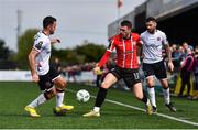 16 April 2023; Ryan Graydon of Derry City in action against Robbie Benson, left, and Robbie McCourt of Dundalk during the SSE Airtricity Men's Premier Division match between Dundalk and Derry City at Oriel Park in Dundalk, Louth. Photo by Ben McShane/Sportsfile