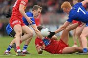 16 April 2023; Michael McKernan of Tyrone is tackled by Jack McCarron, left, and Ryan O'Toole of Monaghan during the Ulster GAA Football Senior Championship Quarter-Final match between Tyrone and Monaghan at O'Neill's Healy Park in Omagh, Tyrone. Photo by Ramsey Cardy/Sportsfile