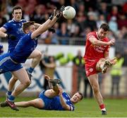16 April 2023; Darren McCurry of Tyrone kicks a  late point despite the efforts of Michael Bannigan of Monaghan during the Ulster GAA Football Senior Championship Quarter-Final match between Tyrone and Monaghan at O'Neill's Healy Park in Omagh, Tyrone. Photo by Sam Barnes/Sportsfile