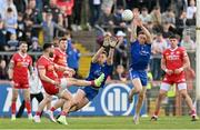 16 April 2023; Monaghan players Michael Bannigan, centre, and Fintan Kelly of Monaghan charge down a late kick by Pádraig Hampsey of Tyrone during the Ulster GAA Football Senior Championship Quarter-Final match between Tyrone and Monaghan at O'Neill's Healy Park in Omagh, Tyrone. Photo by Ramsey Cardy/Sportsfile
