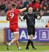 16 April 2023; Referee Niall Cullen and Conn Kilpatrick of Tyrone during the Ulster GAA Football Senior Championship Quarter-Final match between Tyrone and Monaghan at O'Neill's Healy Park in Omagh, Tyrone. Photo by Ramsey Cardy/Sportsfile