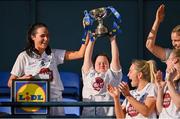 16 April 2023; Kildare supporter Jennifer Malone, from Clane, lifts the cup alongside Kildare captain Grace Clifford, 8, after the 2023 Lidl Ladies National Football League Division 3 Final match between Clare and Kildare at Parnell Park in Dublin. Photo by Piaras Ó Mídheach/Sportsfile