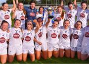 16 April 2023; Kildare captain Grace Clifford, 8, lifts the cup as she celebrates with teammates after their victory in the 2023 Lidl Ladies National Football League Division 3 Final match between Clare and Kildare at Parnell Park in Dublin. Photo by Piaras Ó Mídheach/Sportsfile