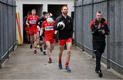 15 April 2023; Conor Glass of Derry leads his side out, alongside Derry manager Rory Gallagher, before the Ulster GAA Football Senior Championship Quarter-Final match between Fermanagh and Derry at Brewster Park in Enniskillen, Fermanagh. Photo by Ramsey Cardy/Sportsfile