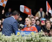 15 April 2023; Kelly Mallon of Armagh receives the cup from Uachtarán Cumann Peil Gael na mBan, Mícheál Naughton after her side's victory in the Lidl Ladies Football National League Division 2 Final match between Armagh and Laois at Croke Park in Dublin. Photo by Sam Barnes/Sportsfile