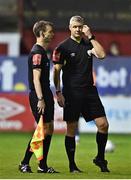 22 September 2022; Referee Ben Connolly, right, and linesman Christopher Campbell during a break in play after a missile was thrown during the SSE Airtricity League Premier Division match between Shelbourne and Shamrock Rovers at Tolka Park in Dublin. Photo by Sam Barnes/Sportsfile