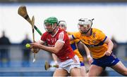 19 April 2023; Ben Cunningham of Cork in action against Oisín Clune of Clare during the oneills.com Munster GAA Hurling U20 Championship Round 4 match between Clare and Cork at Cusack Park in Ennis, Clare. Photo by John Sheridan/Sportsfile