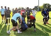 20 April 2023; Leinster Rugby players, together with Emirates Lions Community Rugby Officers, delivered a coaching clinic to the under-16 and under-19 teams, pictured is Leinster Rugby player Will Connors with students at Allen Glen School in Johannesburg, South Africa. Photo by Harry Murphy/Sportsfile