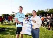 20 April 2023; Leinster Rugby players, together with Emirates Lions Community Rugby Officers, delivered a coaching clinic to the under-16 and under-19 teams, pictured Leinster Rugby player Will Connors presents a signed jersey to Allen Glen master of rugby Hennie van Vuuren with students at Allen Glen High School in Johannesburg, South Africa. Photo by Harry Murphy/Sportsfile