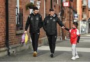 21 April 2023; Neil Farrugia, left, and Dylan Watts of Shamrock Rovers are greeted by a young St Patrick's Athletic supporter as they arrive before the SSE Airtricity Men's Premier Division match between St Patrick's Athletic and Shamrock Rovers at Richmond Park in Dublin. Photo by Seb Daly/Sportsfile