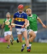 21 April 2023; Jack Leamy of Tipperary in action against Adam English of Limerick during the oneills.com Munster GAA Hurling U20 Championship Round 4 match between Tipperary and Limerick at FBD Semple Stadium in Thurles, Tipperary. Photo by Stephen Marken/Sportsfile