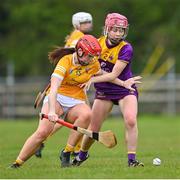 22 April 2023; Anna McKillop of Antrim in action against Sarah Walsh of Wexford during the Electric Ireland Camogie Minor A Shield Semi-Final match between Antrim and Wexford at Coralstown Kinnegad GAA in Westmeath. Photo by Stephen Marken/Sportsfile