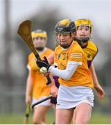 22 April 2023; Shannagh Heggarty of Antrim in action against Katie Bolger of Wexford during the Electric Ireland Camogie Minor A Shield Semi-Final match between Antrim and Wexford at Coralstown Kinnegad GAA in Westmeath. Photo by Stephen Marken/Sportsfile
