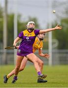 22 April 2023; Leagh Maddock of Wexford in action against Mary McArthur of Antrim during the Electric Ireland Camogie Minor A Shield Semi-Final match between Antrim and Wexford at Coralstown Kinnegad GAA in Westmeath. Photo by Stephen Marken/Sportsfile