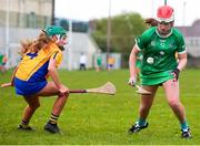 22 April 2023; Niamh Brennan of Limerick in action against Aine Longe of Clare during the Electric Ireland Camogie Minor A Shield Semi-Final match between Clare and Limerick at St Marys Hurling & Camogie Club in Clonmel, Tipperary. Photo by Michael P Ryan/Sportsfile