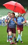 22 April 2023; Piltown AFC players, including Leah Purcell, centre, play with an umbrella on the sidelines during the Aviva Soccer Sisters Finals Day at the Aviva Stadium in Dublin. Photo by Sam Barnes/Sportsfile