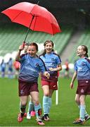 22 April 2023; Piltown AFC players, including Leah Purcell left, play with an umbrella on the sidelines during the Aviva Soccer Sisters Finals Day at the Aviva Stadium in Dublin. Photo by Sam Barnes/Sportsfile