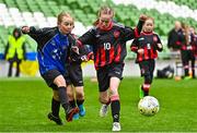 22 April 2023; Róise Gallagher of Kinvara United, Galway, in action against Neasa Keogh of Mungret Regional FC, Limerick, during the Aviva Soccer Sisters Finals Day at the Aviva Stadium in Dublin. Photo by Sam Barnes/Sportsfile