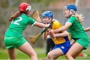 22 April 2023; Nessa Ní Lachtnáin of Clare in action against Limerick players Niamh Brennan, left, and Donna Kenny during the Electric Ireland Camogie Minor A Shield Semi-Final match between Clare and Limerick at St Marys Hurling & Camogie Club in Clonmel, Tipperary. Photo by Michael P Ryan/Sportsfile