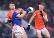 22 April 2023; Dara McVeety of Cavan in action against Rian O'Neill and Ciaran Mackin, right, of Armagh during the Ulster GAA Football Senior Championship quarter-final match between Cavan and Armagh at Kingspan Breffni in Cavan. Photo by Stephen McCarthy/Sportsfile