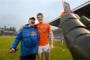 22 April 2023; Jarly Óg Burns of Armagh poses for a photograph with Cavan supporter Pat McCoy after the Ulster GAA Football Senior Championship quarter-final match between Cavan and Armagh at Kingspan Breffni in Cavan. Photo by Stephen McCarthy/Sportsfile