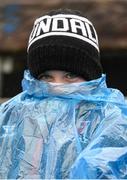 22 April 2023; A young supporter keeps dry during the Ulster GAA Football Senior Championship quarter-final match between Cavan and Armagh at Kingspan Breffni in Cavan. Photo by Stephen McCarthy/Sportsfile