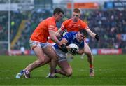 22 April 2023; Oisin Brady of Cavan in action against Conor O'Neill, left, and Ciaran Mackin of Armagh during the Ulster GAA Football Senior Championship quarter-final match between Cavan and Armagh at Kingspan Breffni in Cavan. Photo by Stephen McCarthy/Sportsfile