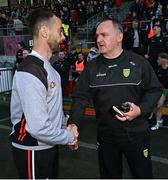 23 April 2023; Down manager Conor Laverty, left, shakes hands with Donegal interim manager Aidan O'Rourke after the Ulster GAA Football Senior Championship Quarter-Final match between Down and Donegal at Pairc Esler in Newry, Down. Photo by Ramsey Cardy/Sportsfile