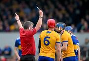 23 April 2023; John Conlon of Clare, 6, looks on as referee Thomas Walsh issues a black card to David McInerney, right, during the Munster GAA Hurling Senior Championship Round 1 match between Clare and Tipperary at Cusack Park in Ennis, Clare. Photo by Ray McManus/Sportsfile