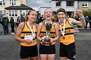 23 April 2023; The Leevale AC, Cork, senior women's team, from left, Michelle Finn, Niamh Moore and Lizzie Lee, celebrate with the cup after winning the senior women's event during the 123.ie National Road Relay Championships at Raheny in Dublin. Photo by Sam Barnes/Sportsfile