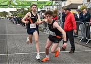 23 April 2023; Ben Coughlan of Clonliffe Harriers AC, Dublin, right, takes over from team-mate Sean Cronin whilst competing in the senior men's event during the 123.ie National Road Relay Championships at Raheny in Dublin. Photo by Sam Barnes/Sportsfile
