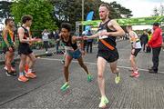 23 April 2023; Efrem Gidey of Clonliffe Harriers AC, Dublin, left, takes over from team-mate Eoin Pierce whilst competing in the senior men's event during the 123.ie National Road Relay Championships at Raheny in Dublin. Photo by Sam Barnes/Sportsfile