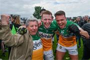 23 April 2023; Offaly supporter Mick McDonagh celebrates with Offaly players Ciaran Donnelly, centre, and Joe Maher after their side's victory in the Leinster GAA Football Senior Championship Quarter-Final match between Offaly and Meath at Glenisk O'Connor Park in Tullamore, Offaly. Photo by Eóin Noonan/Sportsfile