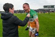 23 April 2023; Declan Hogan of Offaly celebrates with a supporter after his side's victory in the Leinster GAA Football Senior Championship Quarter-Final match between Offaly and Meath at Glenisk O'Connor Park in Tullamore, Offaly. Photo by Eóin Noonan/Sportsfile