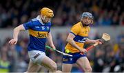 23 April 2023; Jake Morris of Tipperary is tackled by David McInerney of Clare, in the lead up to a Tipperary penalty, during the Munster GAA Hurling Senior Championship Round 1 match between Clare and Tipperary at Cusack Park in Ennis, Clare. Photo by Ray McManus/Sportsfile