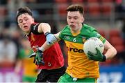 23 April 2023; Darragh Hennigan of Donegal in action against Darren Doherty of Down during the Ulster GAA Football Minor Championship Group A match between Down and Donegal at Pairc Esler in Newry, Down. Photo by Ramsey Cardy/Sportsfile