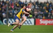 23 April 2023; Peter Cooke of Galway in action against Ben O’Carroll of Roscommon during the Connacht GAA Football Senior Championship Semi-Final match between Roscommon and Galway at Dr Hyde Park in Roscommon. Photo by Seb Daly/Sportsfile