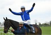 25 April 2023; Jockey Paul Townend celebrates on Energumene with groom Imran Haider after winning the William Hill Champion Steeplechase during day one of the Punchestown Festival at Punchestown Racecourse in Kildare. Photo by Harry Murphy/Sportsfile