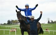 25 April 2023; Jockey Paul Townend celebrates on Energumene with groom Imran Haider after winning the William Hill Champion Steeplechase during day one of the Punchestown Festival at Punchestown Racecourse in Kildare. Photo by Harry Murphy/Sportsfile