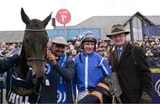 25 April 2023; Jockey Paul Townend, centre, with trainer Willie Mullins and groom Imran Haider after sending out Energumene to win the William Hill Champion Steeplechase during day one of the Punchestown Festival at Punchestown Racecourse in Kildare. Photo by Harry Murphy/Sportsfile