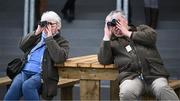 26 April 2023; Racegoers look on during the Adare Manor Opportunity Series Final Handicap Hurdle during day two of the Punchestown Festival at Punchestown Racecourse in Kildare. Photo by Harry Murphy/Sportsfile