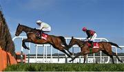 26 April 2023; Gaelic Warrior, left, with Paul Townend up, jumps the last during the first circuit on their way to winning the Irish Mirror Novice Hurdle during day two of the Punchestown Festival at Punchestown Racecourse in Kildare. Photo by Seb Daly/Sportsfile