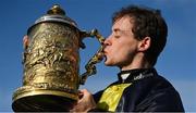 26 April 2023; Jockey JJ Slevin kisses the trophy after winning Ladbrokes Punchestown Gold Cup on Fastorslow during day two of the Punchestown Festival at Punchestown Racecourse in Kildare. Photo by Seb Daly/Sportsfile